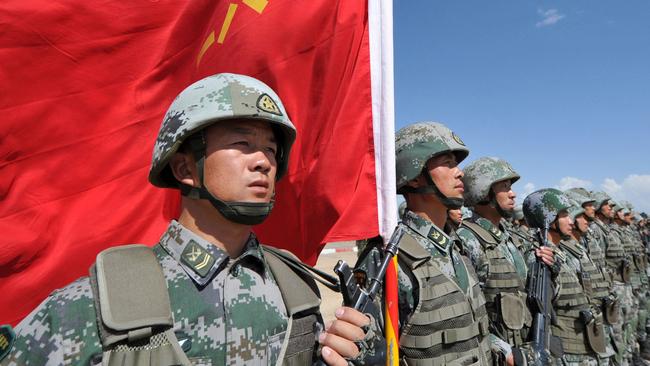 A Chinese soldier holds a flag during joint military exercises in Balykchy, Kyrgyzstan. Picture: AFP