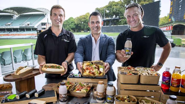 Fleurieu Milk Company general manager Nick Hutchinson, Adelaide Oval chief executive Nick Addison and Crows legend Tony Modra with a selection of food and drinks available at Adelaie Oval. Picture: Mark Brake