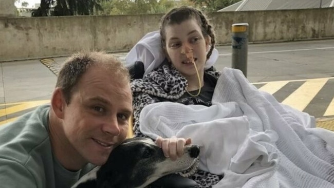 Nicole with her husband Dave and their dog, after the unexpected stroke.