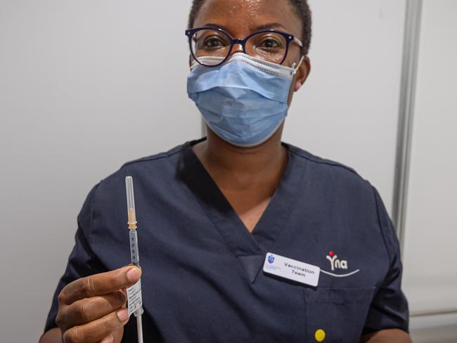 Nurse Onyinyechi Okorie administers Vaccine. Phase 1B COVID-19 vaccination rollout begins inside mass COVID jab hub at historic Royal Exhibition Building. Picture: Jason Edwards