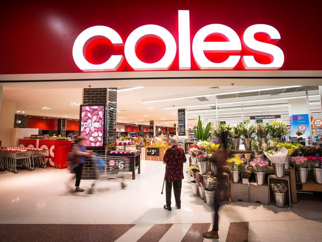 A shopper stands at the entrance to a Coles supermarket, operated by Wesfarmers Ltd., in Sydney, Australia, on Tuesday, Feb. 18, 2014. Wesfarmers, Australia's largest employer, is scheduled to report first-half earnings on Feb. 19. Photographer: Ian Waldie/Bloomberg via Getty Images