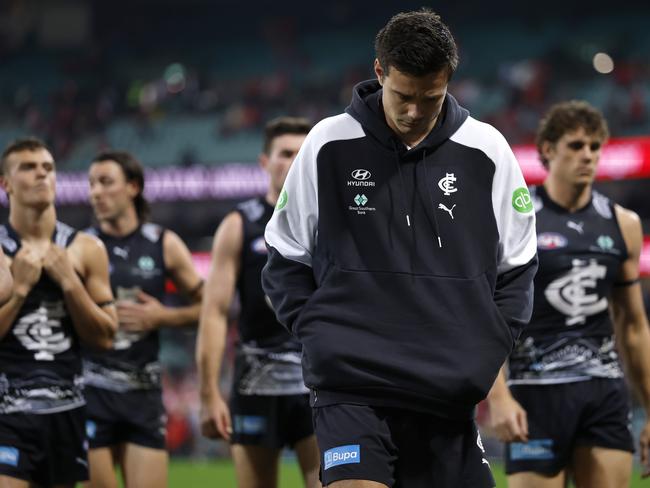 Jack Silvagni leads the Blues off after being injured against Sydney.