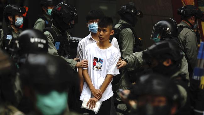 Protesters in Hong Kong are detained as the city’s politicians debate a bill that would criminalise insulting China’s national anthem. Picture: AP