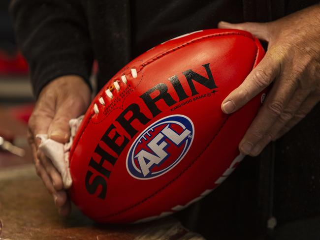 Staff work on the production of Sherrin footballs to be used in the 2019 AFLW Grand Final, at the Sherrin Factory in Scoresby, Melbourne, Thursday, March 28, 2019. (AAP Image/Daniel Pockett) NO ARCHIVING, EDITORIAL USE ONLY
