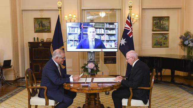 Australian Prime Minister Scott Morrison (left) and Australian Governor-General David Hurley attend as Alex Hawke MP is sworn-in as Minister for Immigration during a virtual swearing-in ceremony at Government House. Picture: Getty