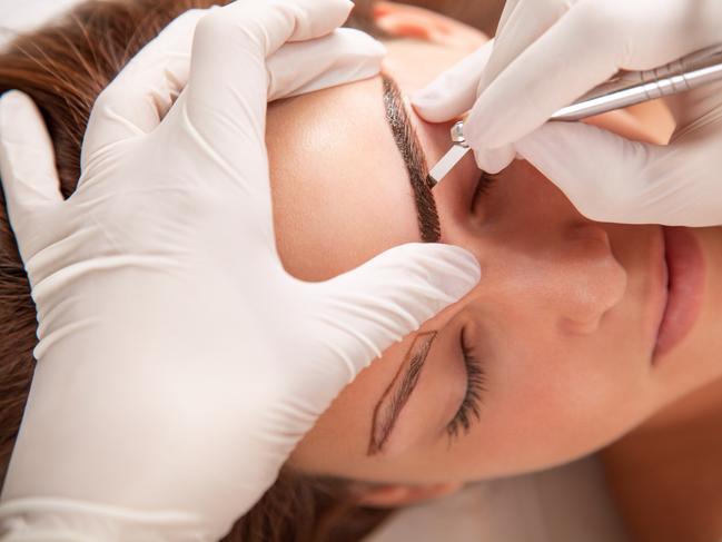 A young woman is receiving eyebrow treatment. Picture: iStock.