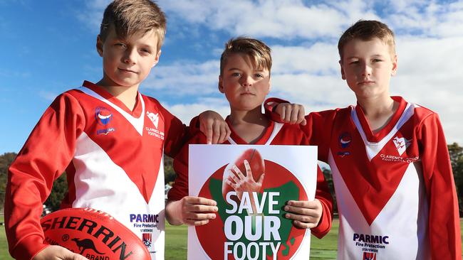 Clarence Junior Football Club players Lochie Davey, left, Riley Whitelaw and Blake Garrett, all 10, love playing football in Tasmania. Picture: LUKE BOWDEN