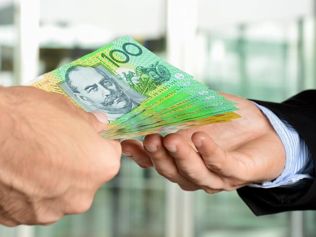 Hands of businessmen passing money, Australia dollar bills
