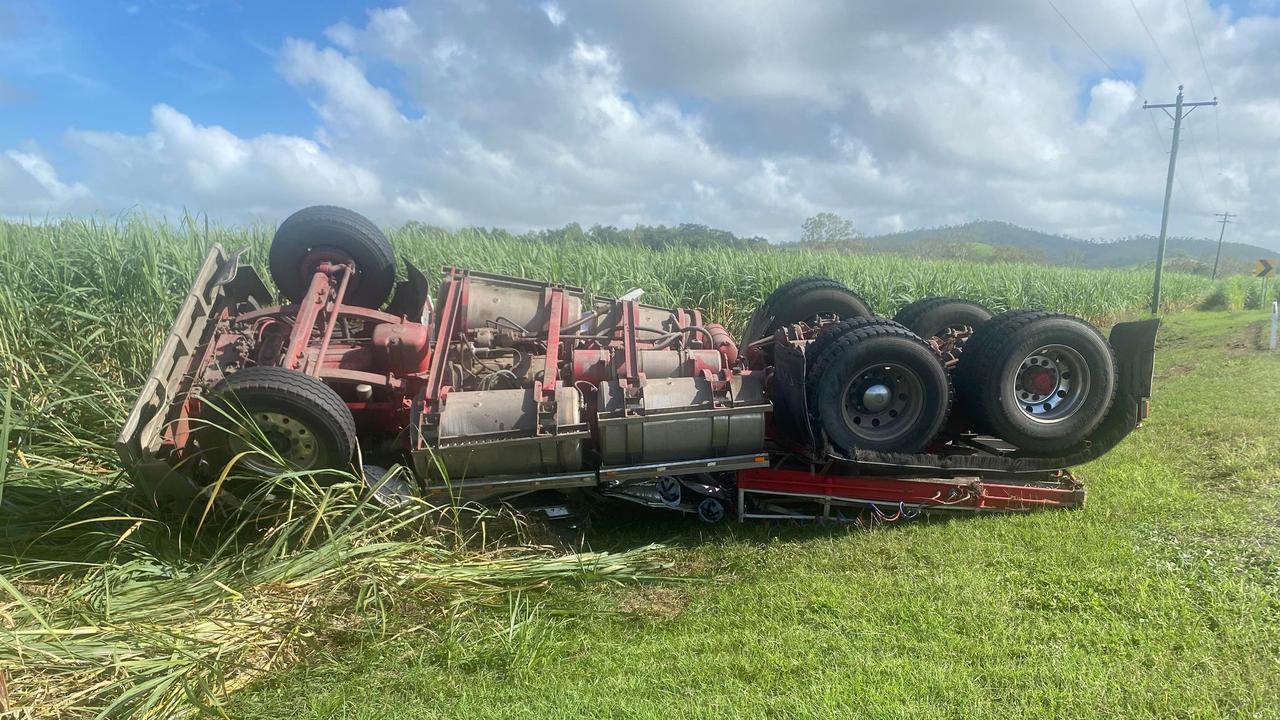 A truck driver is pinned inside a crushed truck cabin after it rolled into a cane paddock near Oakenden on Eton Homebush Rd, February 18, 2022. Picture: Matthew Forrest