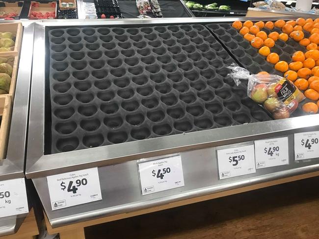 Empty fruit shelves at Coles Box Hill Central.