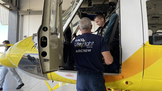 Aircrewman John Kennedy shows Eli inside the LifeFlight Rescue Helicopter.