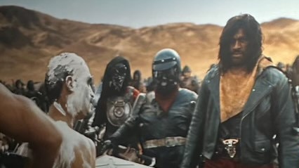 Paul Price, wearing the red scarf in the middle of the frame, playing a small part in Furiosa: A Mad Max Saga.