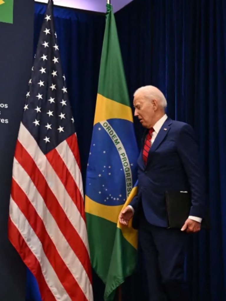 Joe Biden bumped into the flag. Picture: AFP via Getty Images