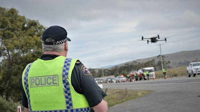 Sergeant Mark Woodland with a Tasmania Police drone. Generic image. Picture: Kenji Sato