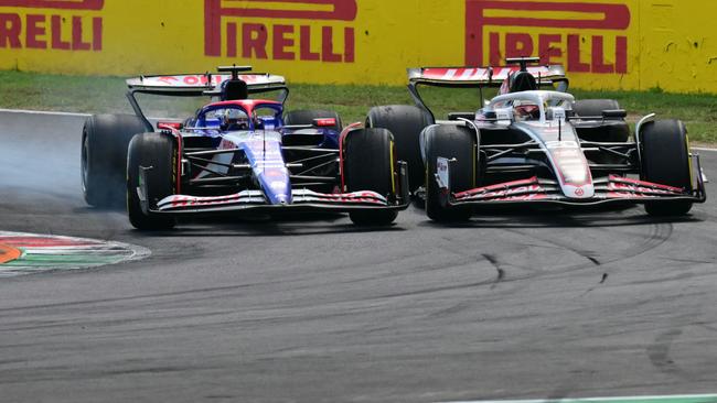 Ricciardo and Kevin Magnussen fighting around one corner. (Photo by Andrej ISAKOVIC / AFP)