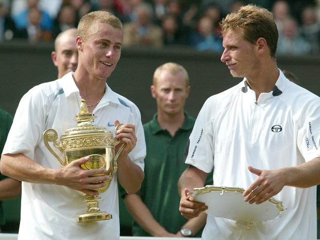 Lleyton Hewitt, left, and Argentina's David Nalbandian hold their trophies, after the Men's Singles final at Wimbledon in 2002. AP Photo/Ted S. Warren.