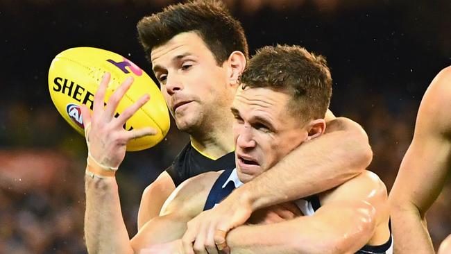 Joel Selwood is tackled by Trent Cotchin early in Friday night\s qualifying final. Picture: Getty Images