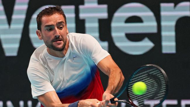 Croatia's Marin Cilic returns the ball during the men's singles semifinal