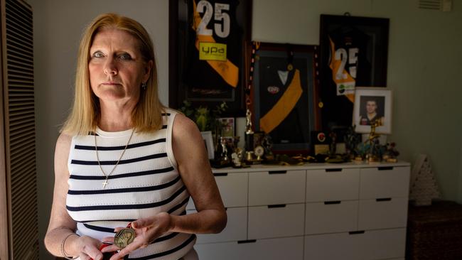 Evelyn Brown holding Steven’s best and fairest medal. Picture: Jason Edwards