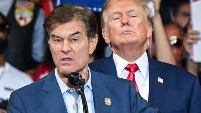 (FILES) Mehmet Oz, who is running for the US Senate, speaks as former US President Donald Trump stands behind him during a campaign rally in support of Oz and Doug Mastriano for Governor of Pennsylvania at Mohegan Sun Arena in Wilkes-Barre, Pennsylvania on September 3, 2022. President-elect Donald Trump on November 19, announced the nomination of Dr. Mehmet Oz to serve as the Centers for Medicare and Medicaid Services (CMS) Administrator. (Photo by Ed JONES / AFP)