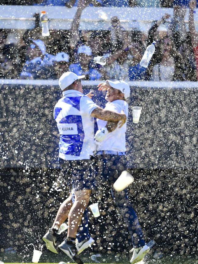 . . . as he celebrated the amazing hole in one with his caddie. Picture: Mark Brake/Getty Images