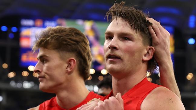 PERTH, AUSTRALIA - AUGUST 02: Will Graham and Bailey Humphrey of the Suns walk from the ground after being defeated during the round 21 AFL match between West Coast Eagles and Gold Coast Suns at Optus Stadium, on August 02, 2024, in Perth, Australia. (Photo by Paul Kane/Getty Images)