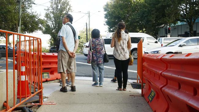 Pedestrians waiting to cross to Green square station at the Pedestrian crossing to Green Square station at the intersection of Botany Road and O’Riorden street, Zetland. Picture: John Appleyard