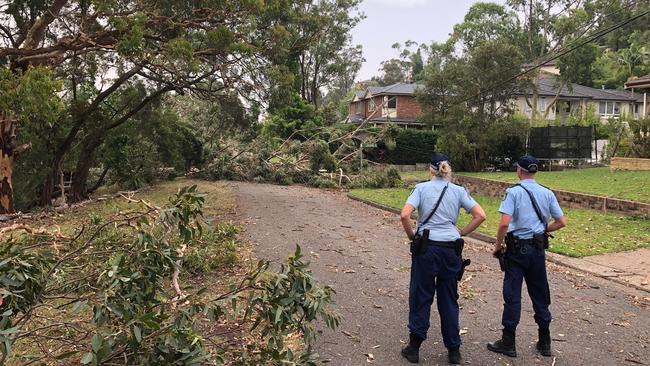 Police warn residents to stay indoors in Andrew St, Davidson, due to fears over stretched powerlines breaking. Picture: Jim O'Rourke.