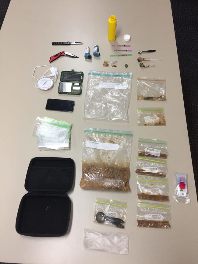 Drugs and items uncovered during a police search in Airlie Beach on Thursday. Police allege more than 1kg of MDMA was uncovered.