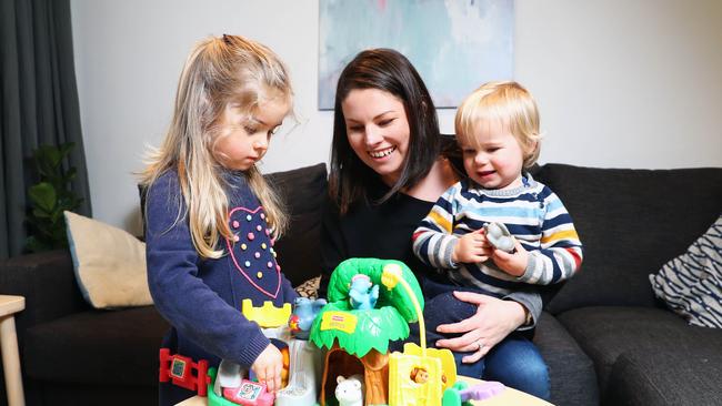 Melbourne mother Sophie Cummins with her children Olivia, 4, and Josh, 2, who are excited that toy libraries are to reopen in a week. Picture: Aaron Francis