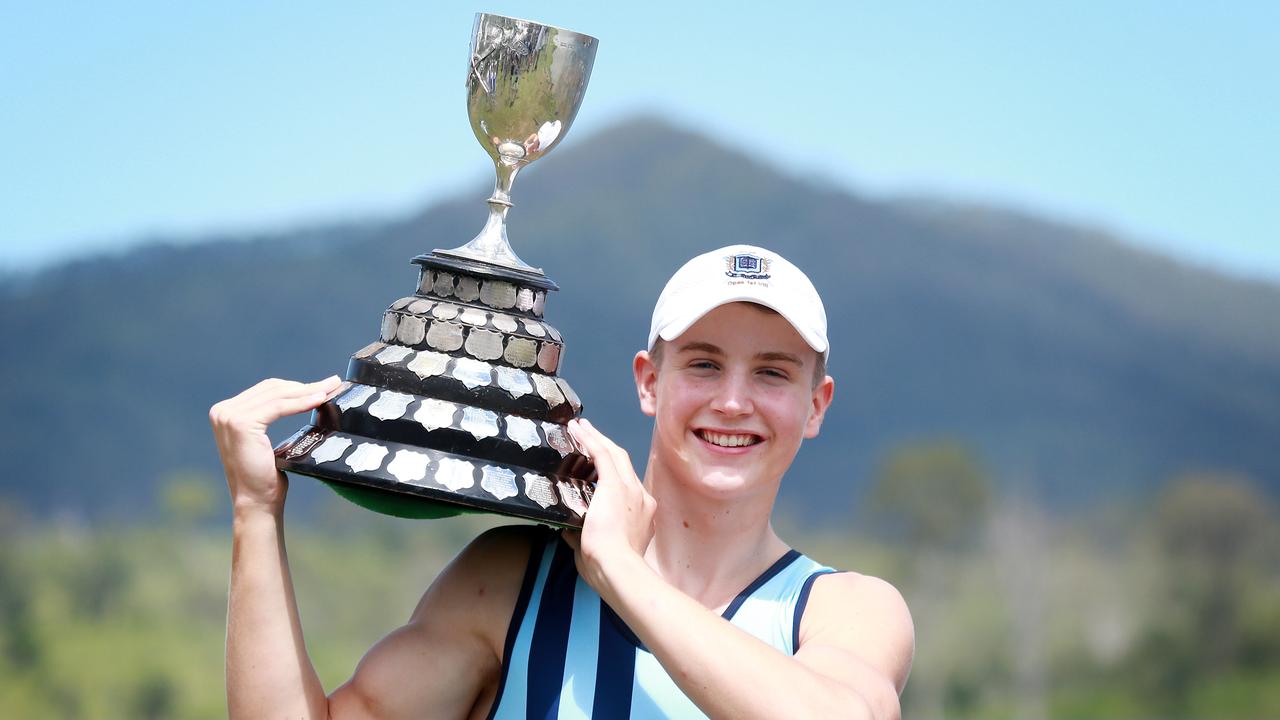 Brisbane Grammar School rowing captain Hugh Weightman hoists the O’Connor Cup after his crew won the GPS Head of the River on Saturday. Picture: AAP