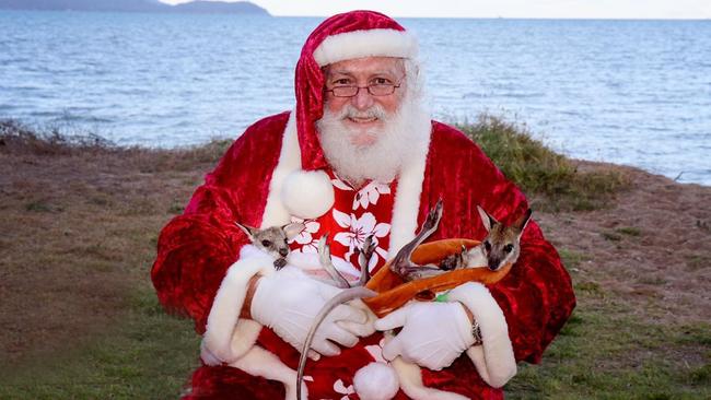 Tropical Santa Claus Lyle McGrath will spend his seventh year taking photos with families at Rowes Bay in collaboration with Jacqualyn Louise Photography.