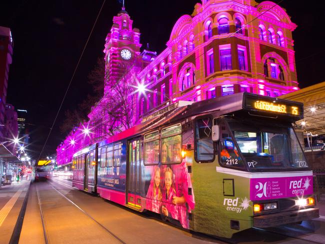 Flinders Street illuminated with pink light for breast cancer awareness. Picture: Jeremy Heffernan