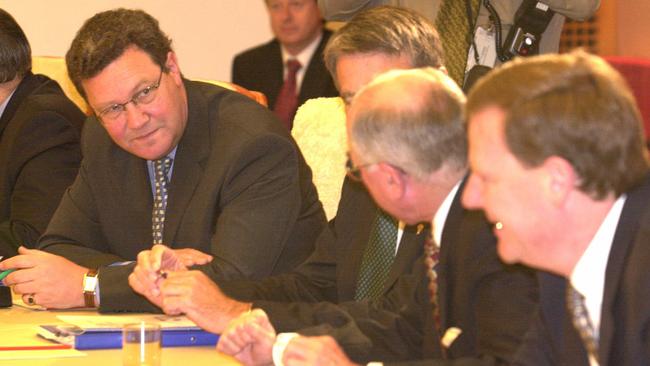 Foreign Affairs Minister Alexander Downer (left), Prime Minister John Howard (second from right) and Treasurer Peter Costello (right) at a Cabinet meeting in Parliament House, Canberra, on November 27, 2001.