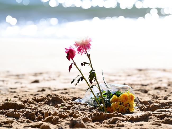 Flowers left on Palm Beach as part of the traditional paddle out farewell for Mark Sanguinetti. Picture: NCA NewsWire / Jeremy Piper