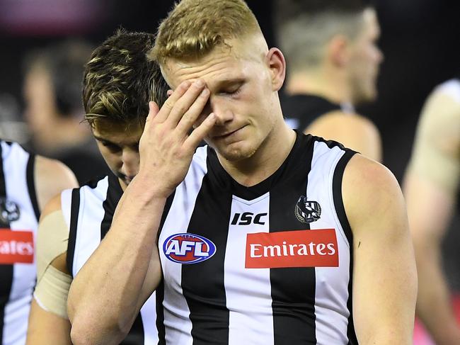 Adam Treloar of the Magpies reacts (centre) after the Round 15 AFL match between the Collingwood Magpies and the North Melbourne Kangaroos at Marvel Stadium in Melbourne, Saturday, June 29, 2019. (AAP Image/Julian Smith) NO ARCHIVING, EDITORIAL USE ONLY