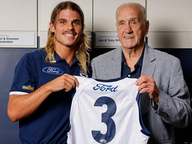 GEELONG, AUSTRALIA - DECEMBER 06: Fred Wooller, the Cats 1963 Premiership Captain poses for a photo with new recruit Bailey Smith and presents him with his number #3 jumper which Bailey will wear in the 2025 season during a Geelong Cats Media Opportunity at GMHBA Stadium on December 06, 2024 in Geelong, Australia. (Photo by Dylan Burns/AFL Photos)