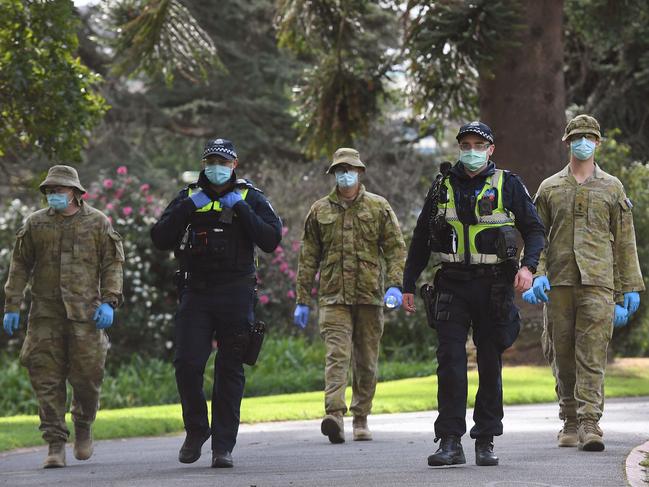 Police and soldiers patrol Treasury Gardens in Melbourne. Picture: AFP