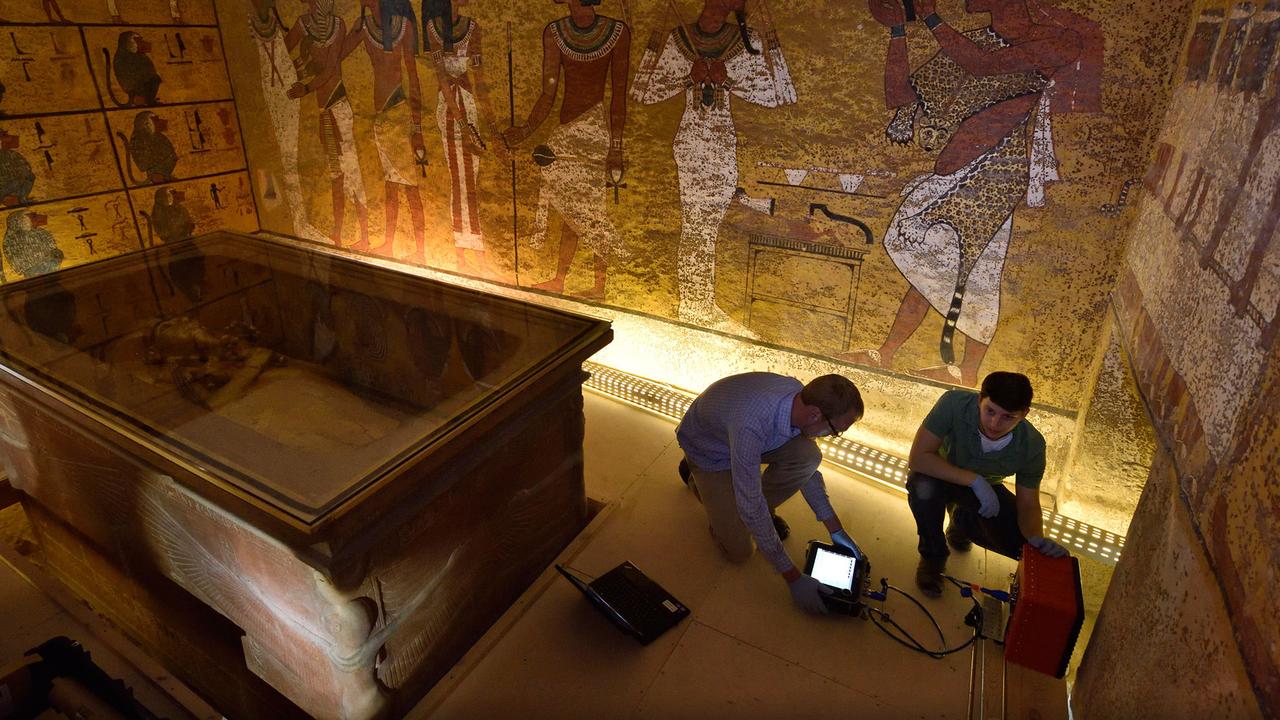 Crouched by King Tut’s stone sarcophagus, technicians Eric Berkenpas and Alan Turchik prepare the radar unit to scan the tombs walls. Picture: Kenneth Garrett/National Geographic/Egyptian Ministry of Antiquities 