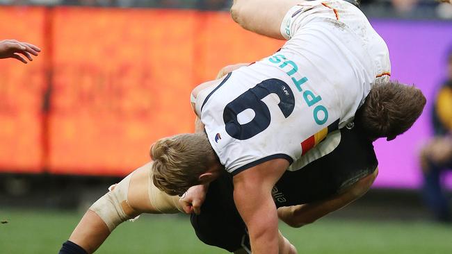 Adelaide co-captain Rory Sloane tries to find a way to stop Patrick Cripps on Saturday. Picture: Michael Klein