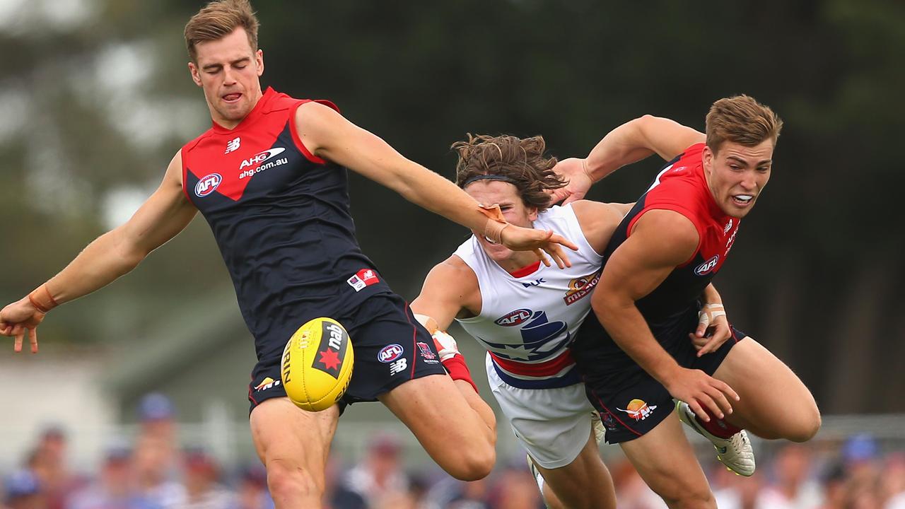 BALLARAT, AUSTRALIA - MARCH 14: Dom Tyson of the Demons kicks as Jack Viney of the Demons shepherds Marcus Bontempelli of the Bulldogs during the NAB Challenge AFL match between the Western Bulldogs and the Melbourne Demons at Eureka Stadium on March 14, 2015 in Ballarat, Australia. (Photo by Quinn Rooney/Getty Images)