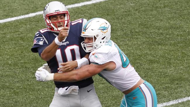 Miami Dolphins linebacker Kiko Alonso, right, hits New England Patriots quarterback Jimmy Garoppolo.