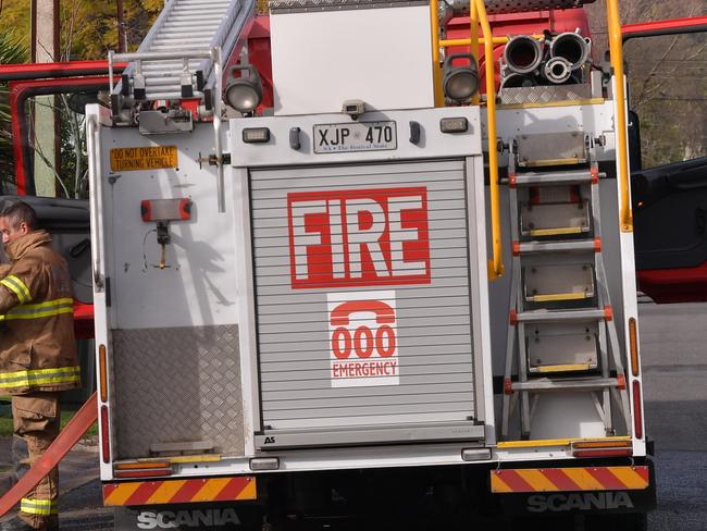 Fire fighters attend a house fire in a suburban Street in Netherby, Adelaide, Monday, August 14, 2017. A 12-year-old boy has died and a 65-year-old man is fighting for life after a house fire in Adelaide. (AAP Image/David Mariuz) NO ARCHIVING