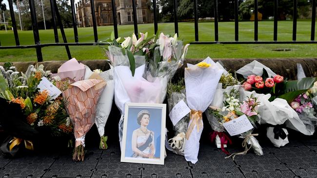 Flowers placed along the fence outside Government House in Sydney in memory of the Queen. Picture: NCA NewsWire / Jeremy Piper