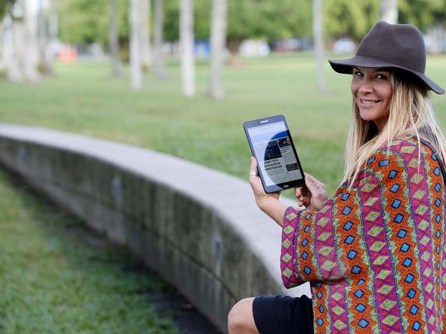 Tulani Lockhart of Whitfield reading the Cairns Post news on the Samsung tablet. PICTURE: STEWART MCLEAN