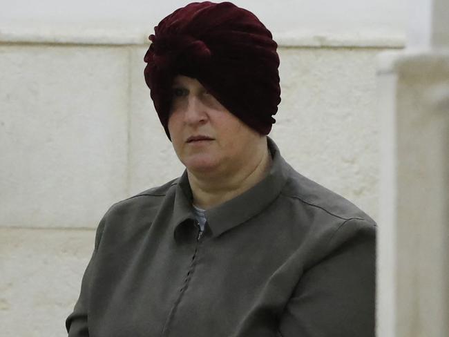 (FILES) In this file photo taken on February 27, 2018 Malka Leifer, a former Australian teacher accused of dozens of cases of sexual abuse of girls at a school, arrives for a hearing at the District Court in Jerusalem. - Leifer was on April 3, 2023 found guilty of sexually assaulting girls at an ultra-orthodox Jewish school in Australia, 15 years after she escaped arrest by fleeing to Israel. (Photo by AHMAD GHARABLI / AFP)