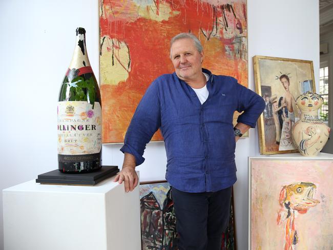 11/03/2021. Tim Olsen at Bonhams auction house Woollahra in Sydney's Eastern suburbs ahead of the auction for LUCIOÃS: Food, Art & Friendship. Taking place on Sunday 21 March, the auction will present 168 works by many of AustraliaÃ&#149;s most respected artists, spanning the restaurantÃs almost 40 years of history and celebrating Lucio and Sally GallettoÃs contribution to AustraliaÃs culinary and art landscapes. Tim pictured with large bottle of Bollinger decorated by his father John Olsen in 1992. Britta Campion / The Australian