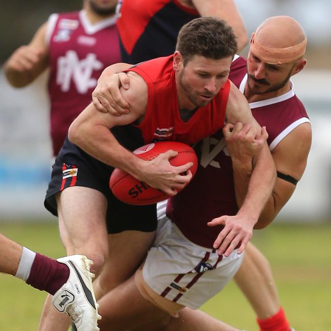 Wycheproof-Narraport’s Justin Bateson is tackled by Nullawil’s Zac Caccaviello.