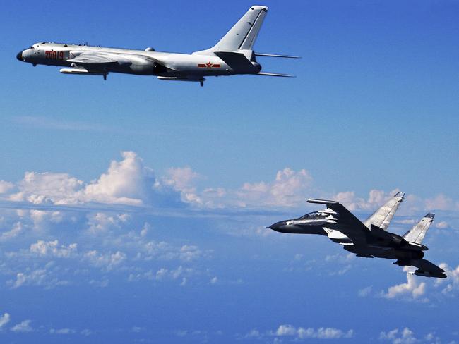 FILE - In this Sept. 25, 2016 file photo released by Xinhua News Agency, Chinese People's Liberation Army Air Force Su-30 fighter, right, flies along with a H-6K bomber as they take part in a drill near the East China Sea. China patrolled the waters of a series of hotly contested islands on Sunday, Dec. 11, 2016, a day after staging a flyover of two strategically important waterways near Taiwan and Japan. (Shao Jing/Xinhua via AP, File)
