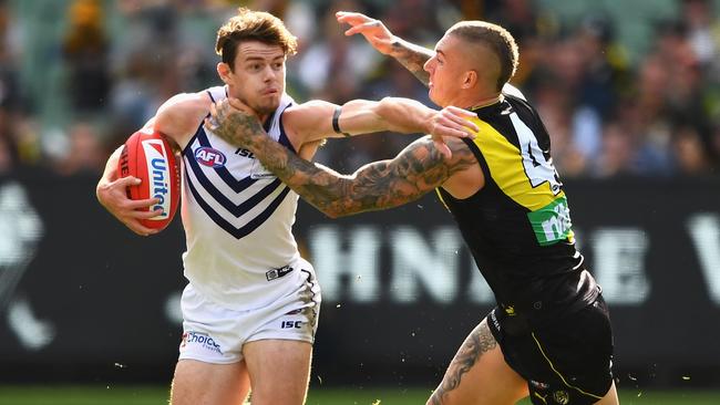 Lachie Neale tries to fend off Dustin Martin.